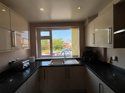 a kitchen with a sink and a window at SmithStayz Poulton in Poulton le Fylde
