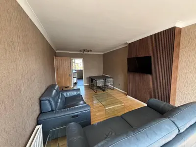 a living room with a couch and a table at SmithStayz Poulton in Poulton le Fylde