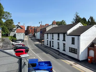 a street with cars parked on the side of a building at SmithStayz Poulton in Poulton le Fylde