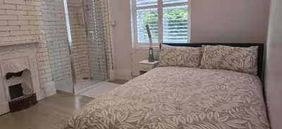a bedroom with a bed and a fireplace at 8 Guests - Free Parking - Full Equipped House in Saint Helens