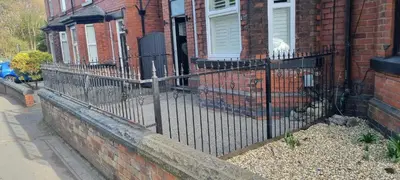 a wrought iron fence in front of a house at 8 Guests - Free Parking - Full Equipped House in Saint Helens