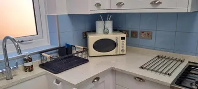 a microwave sitting on a counter in a kitchen at 8 Guests - Free Parking - Full Equipped House in Saint Helens