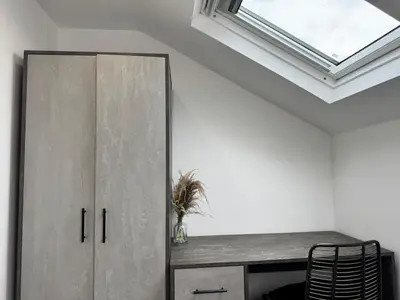 a room with a cabinet and a skylight at 6B 3Bath - Free Parking - TVs In EVERY Room in Liverpool