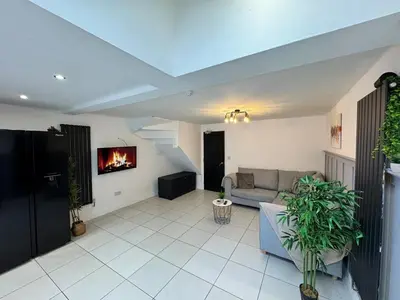 a living room with a couch and a fireplace at 6B 3Bath - Free Parking - TVs In EVERY Room in Liverpool