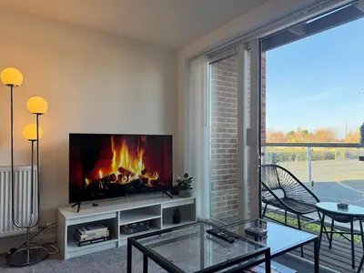 a living room with a fire in the fireplace at Coastal 2 Bathroom Apartment, Free Parking in Moreton