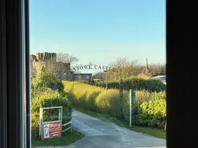 a view from a window of a sign for some castle at Coastal 2 Bathroom Apartment, Free Parking in Moreton