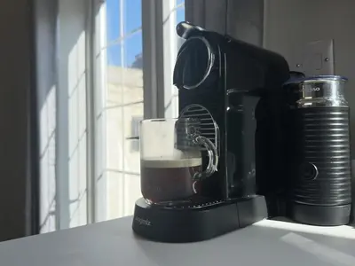 a coffee maker with a cup of coffee on a counter at Stylish Highland-Theme 2BR Sefton Park in Liverpool