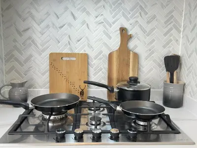 a stove top with two pots and pans on it at Stylish Highland-Theme 2BR Sefton Park in Liverpool