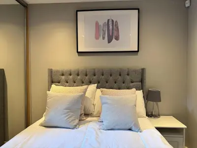 a bedroom with a large bed with white pillows at Balcony Free Parking Huge TV City Centre Apt in Liverpool