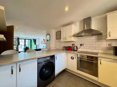 a kitchen with a washer and dryer in it at Balcony Free Parking Huge TV City Centre Apt in Liverpool
