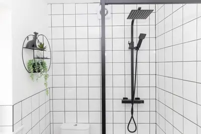 a shower with a toilet in a white tiled bathroom at Very Spacious 2 Bath Free Parking in Liverpool