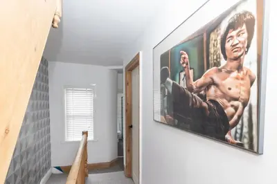 a hallway with a large painting on the wall at Very Spacious 2 Bath Free Parking in Liverpool