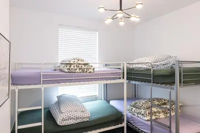 a room with three bunk beds with pillows at Very Spacious 2 Bath Free Parking in Liverpool