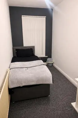a bedroom with a large bed in a room at Room in Anfield 5 minute walk to stadium in Liverpool