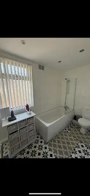 a bathroom with a tub and a sink and a toilet at Room in Anfield 5 minute walk to stadium in Liverpool