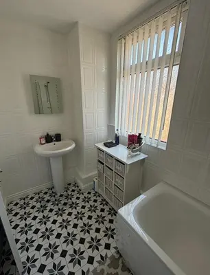 a white bathroom with a sink and a tub and a sink at Room in Anfield 5 minute walk to stadium in Liverpool