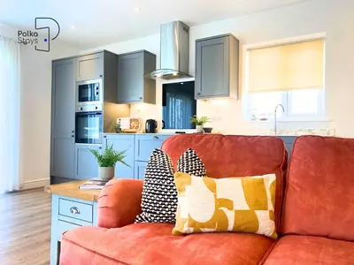 a living room with a couch and a kitchen at No 5 PolkaStays Ivy Farm Paddock Lodge in Brown Moss Side