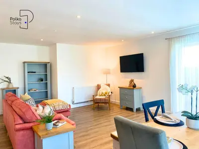 a living room with a couch and a table at No 5 PolkaStays Ivy Farm Paddock Lodge in Brown Moss Side