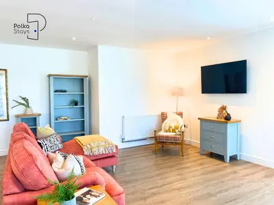 a living room with a couch and a tv at No 5 PolkaStays Ivy Farm Paddock Lodge in Brown Moss Side