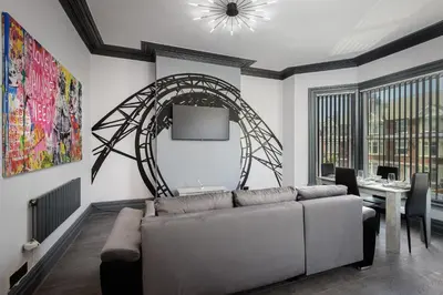 a living room with a couch and a table at The Coaster Loft Apartments by STAMP SA in Blackpool