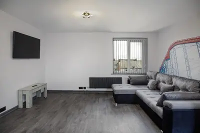 a living room with a couch and a tv at The Coaster Loft Apartments by STAMP SA in Blackpool