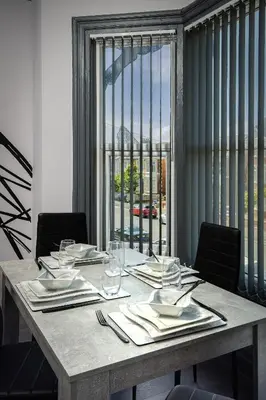 a table with plates and napkins on top at The Coaster Loft Apartments by STAMP SA in Blackpool