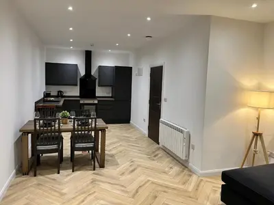 a kitchen and dining room with a table and chairs at Oceans 45 in Blackpool