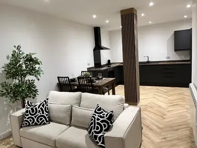 a living room with a couch and a kitchen at Oceans 45 in Blackpool