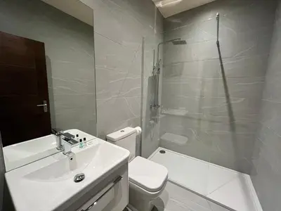 a bathroom with a sink and a toilet and a shower at Oceans 45 in Blackpool