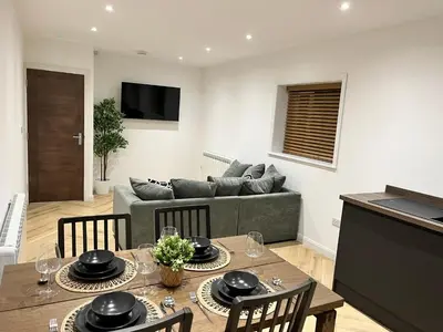 a living room with a table and a couch at Oceans 45 in Blackpool