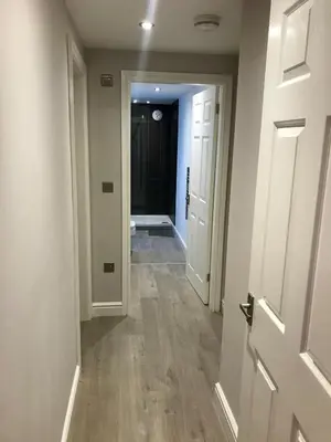 an empty hallway with an open door and a hallway at Barrow Centre Stylish 1 Bed flat in Barrow in Furness