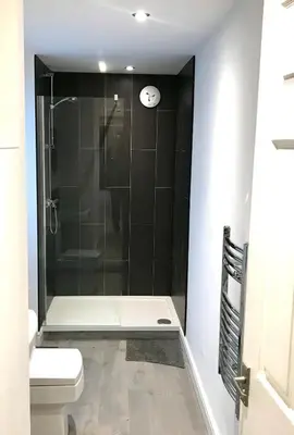 a bathroom with a shower and a toilet at Barrow Centre Stylish 1 Bed flat in Barrow in Furness