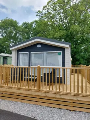 a tiny house with a wooden fence at Luxury 6 berth Caravan Lytham in Preston