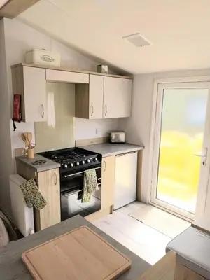 a small kitchen with a stove and a window at Luxury 6 berth Caravan Lytham in Preston