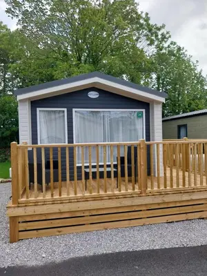 a wooden bench in front of a tiny house at Luxury 6 berth Caravan Lytham in Preston
