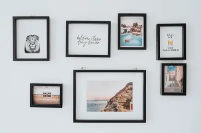 a group of framed pictures on a wall at Castle St Steps to Ivy Washer Pet-Friendly in Liverpool
