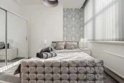 a bedroom with a large bed in a white room at Castle St Steps to Ivy Washer Pet-Friendly in Liverpool