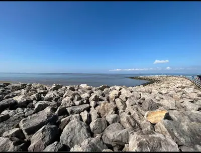 a large group of rocks on the beach at The Rainbow's nest in Morecambe