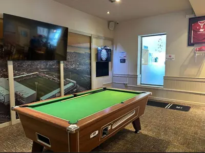 a room with a pool table and a flat screen tv at The Rainbow's nest in Morecambe