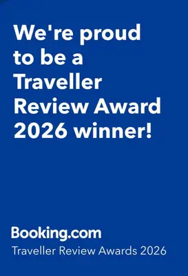 a blue sign that says were proud to be a traveller review award winner at The Rainbow's nest in Morecambe