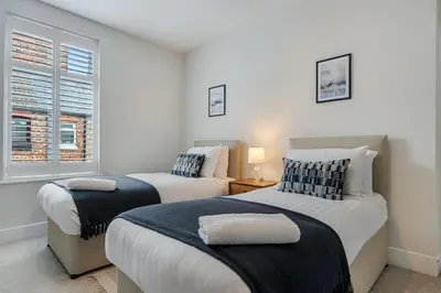 a bedroom with two beds and a window at Watford Lodge - Air Host & Stay - A Home in the Heart of Anfield in Liverpool
