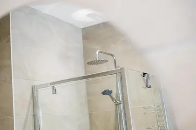 a shower with a glass door in a bathroom at Watford Lodge - Air Host & Stay - A Home in the Heart of Anfield in Liverpool