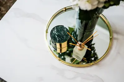 a mirror with a vase of flowers on a table at Watford Lodge - Air Host & Stay - A Home in the Heart of Anfield in Liverpool