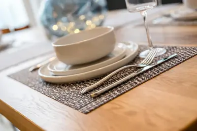 a table with a plate and a cup and fork and knife at Watford Lodge - Air Host & Stay - A Home in the Heart of Anfield in Liverpool
