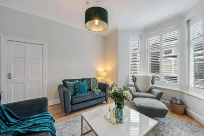 a living room with a couch and a table at Watford Lodge - Air Host & Stay - A Home in the Heart of Anfield in Liverpool