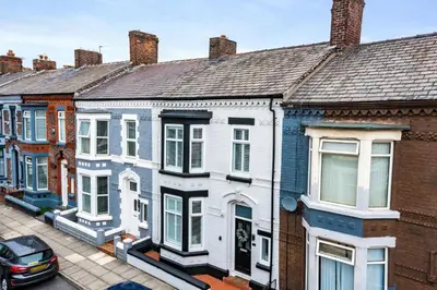 a row of houses on a city street at Watford Lodge - Air Host & Stay - A Home in the Heart of Anfield in Liverpool