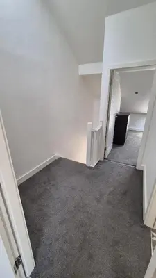 an empty room with white walls and carpet at Spacious & Modern house in St Helens in Saint Helens