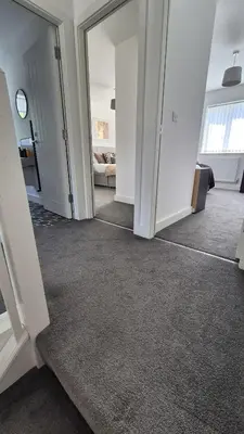 an empty room with a hallway with a living room at Spacious & Modern house in St Helens in Saint Helens