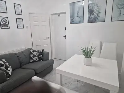 a living room with a couch and a table at Excellent Suite Room in Liverpool in Liverpool