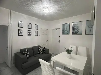 a living room with a couch and a table at Excellent Suite Room in Liverpool in Liverpool
